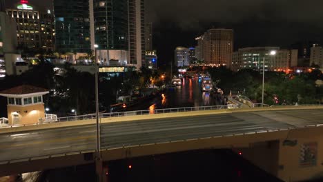 Aerial-tilt-up-shot-of-bridge-in-downtown-of-Fort-Lauderdale-at-night