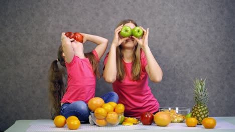 happy family covering eyes. daughter with mom covering eyes with apples