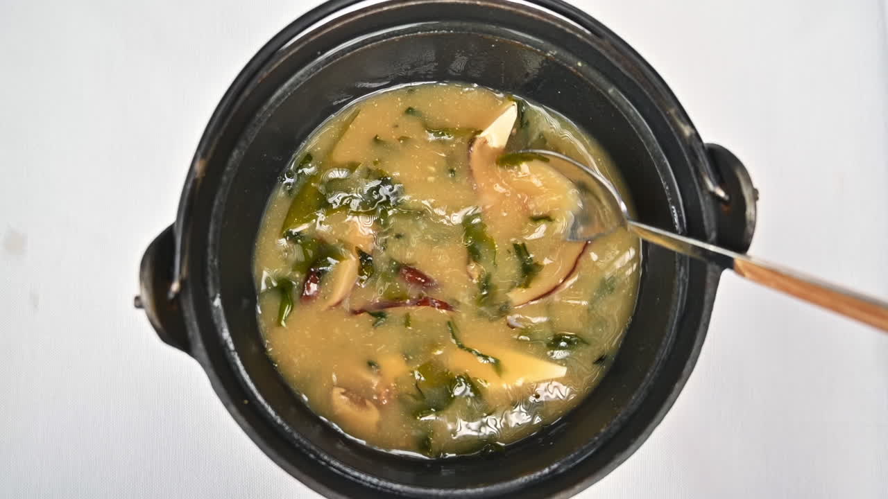 Japanese seaweed miso soup with tofu cheese, slow motion stir