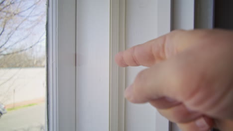 gimbal shot of a hand pointing to the inside of a window frame