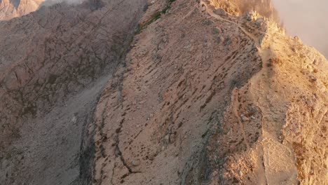 Tilt-pan-up-of-the-mountain-hut-Nuvolau,-during-sunset-in-the-Dolomites,-Cinque-Torri