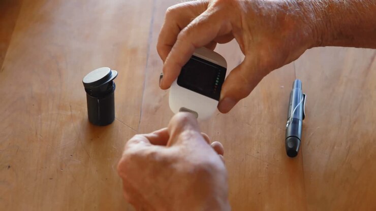Senior man checking blood sugar on glucometer 4k