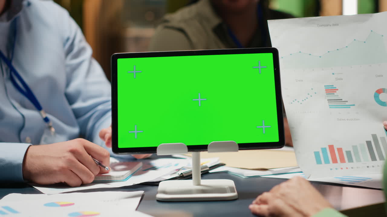 Diverse company workers hold phone with isolated chroma key