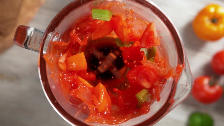 Tomato Weight Loss Smoothie With Celery Mixed In A Glass Blender In Slow Motion, Top View, Inside of the Device