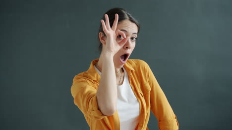 woman making funny face with ok hand gesture