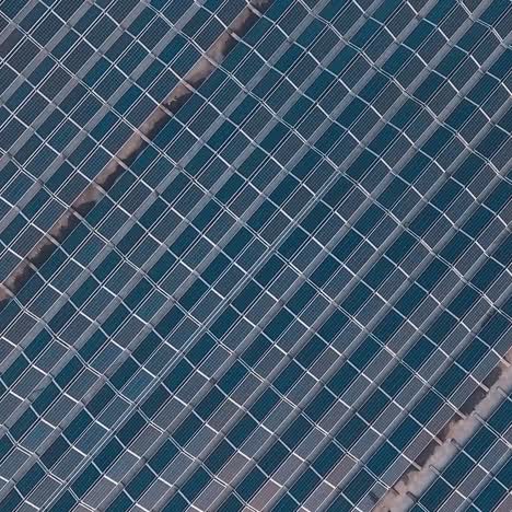 huge innovative solar farm. photovoltaic solar panels on the flat roof of the building. alternative energy. motion camera around. aerial view.