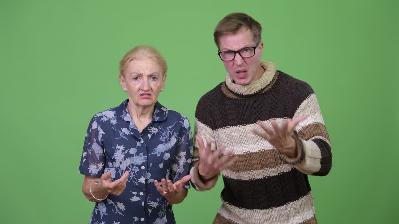 Angry grandmother and grandson talking and gesturing in rage together