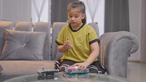 Smart-Indian-kid-girl-fixing-robot-electric-car