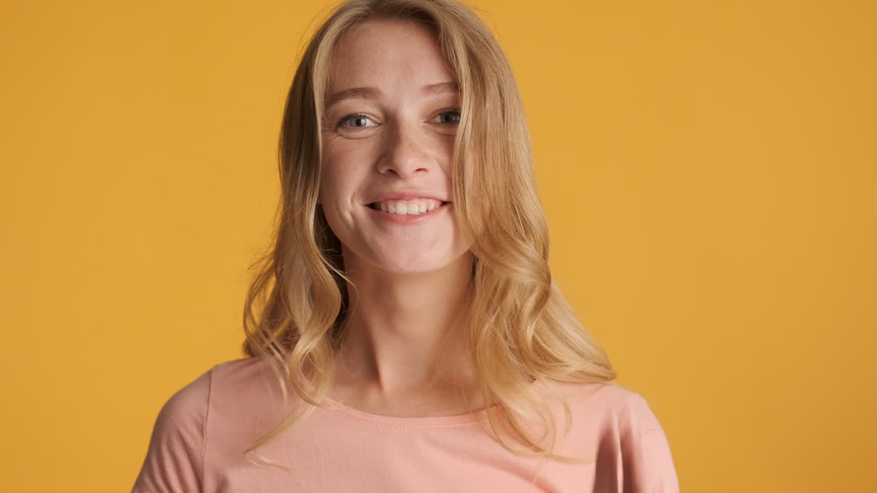 Caucasian woman laughing on camera.