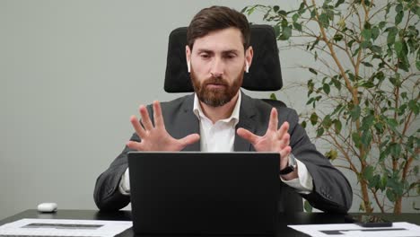 confident bearded businessman ceo wear suit speaking looking at webcam of laptop in office, male executive manager talking make conference online video chat call job interview recording online course.