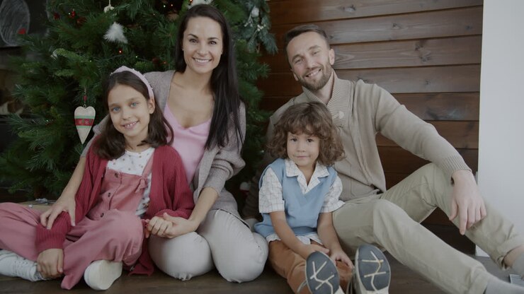Happy Family Portrait by Christmas Tree