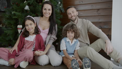 happy family portrait by christmas tree