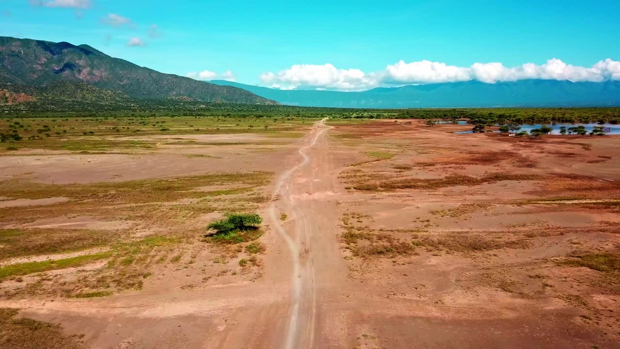 Fly Over Dirt Road In Safari Tours Near Lake Magadi In Kenya, East Africa. Aerial Drone Shot