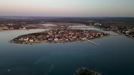 drone flight over the sea to a peninsula in croatia city nin