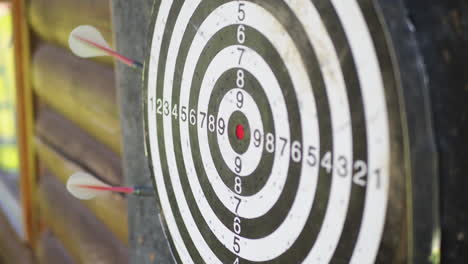 throwing darts arrows and missing to hit the target