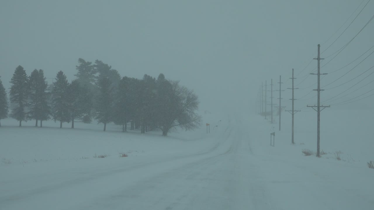 Driving on a Snowy Rural Road During a Winter Blizzard
