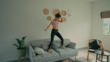 happy woman jumping on sofa