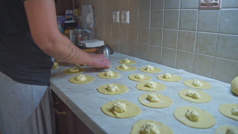 CLOSEUP-footage-of-a-woman-preparing-home-made-greek-cheese-pies