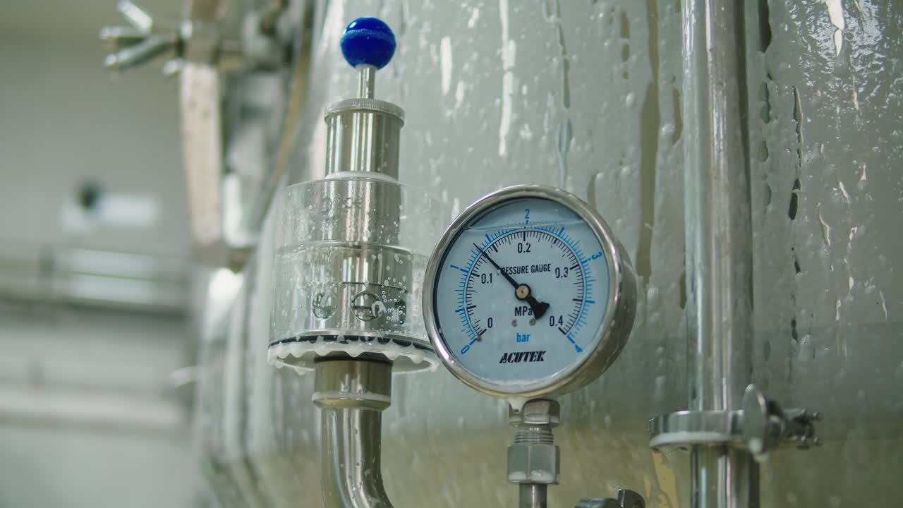 Craft beer production, general cleaning on factory, brewery manufacture. Washing metal vats bottles. Brewing, cooking alcohol