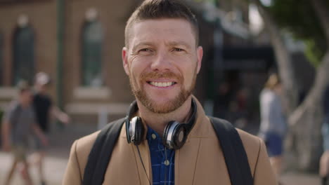 slow motion portrait of charming caucasian man smiling happy in urban background