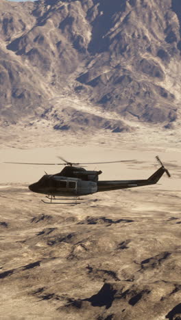 helicopter flying over desert mountains