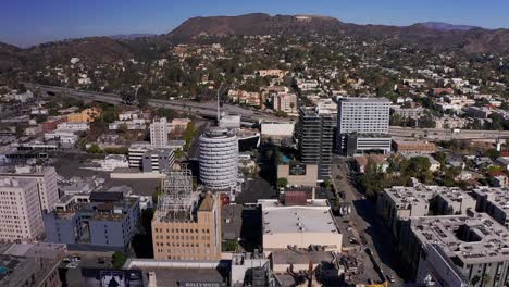 aerial tilting up shot of downtown hollywood with the hollywood sign in the background