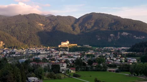 aerial view of mountain town kufstein with hilltop fortress, summer scenery at sunrise, river inn meandering through the valley - austrian alps , tyrol, austria, europe