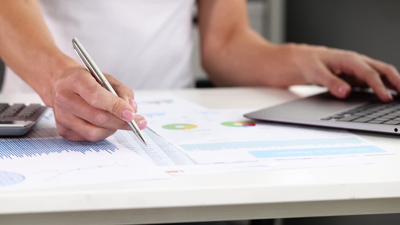 Financial analysis with calculator and laptop