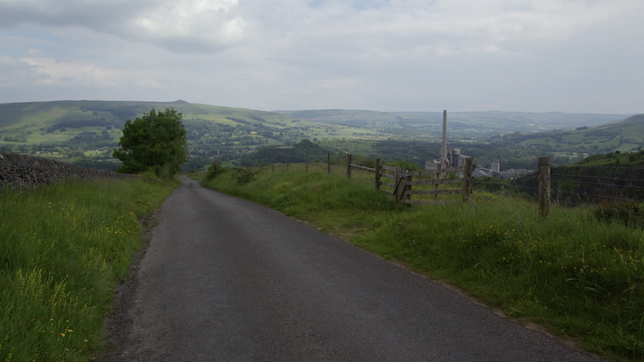 A Winding Rural Road Through Green Hills and Valley