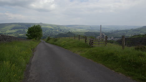 a winding rural road through green hills and valley