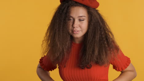 caucasian curly haired woman wearing a beret.