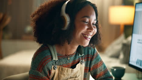 woman working on computer with headphones