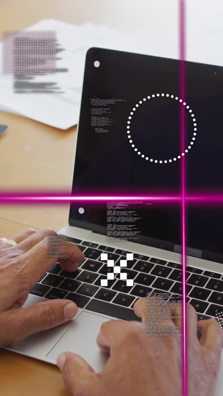 Vertical video: Man placing hands on keys coding for work as magenta overlay moving across screen