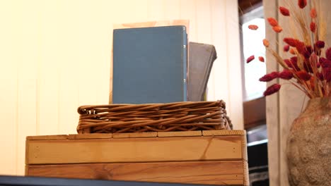 books, basket, and dried flowers decor