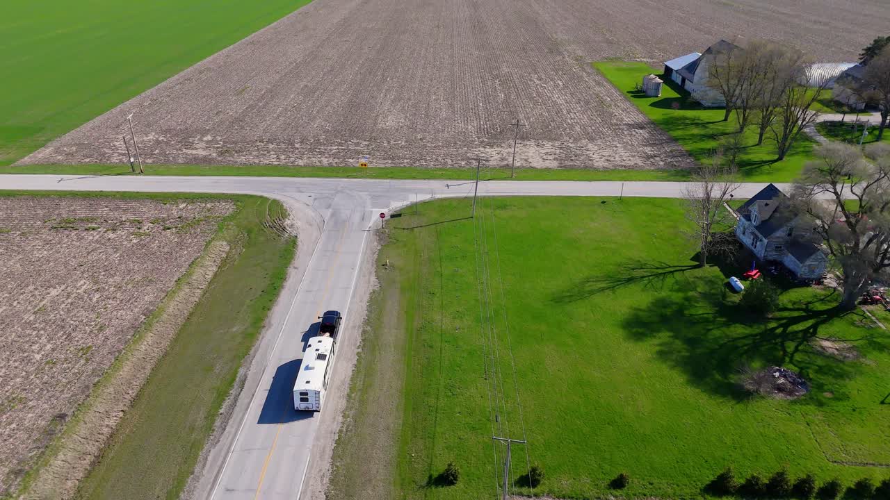 Rural Road Between Fields in Midwest USA with Truck Hauling Horse trailer