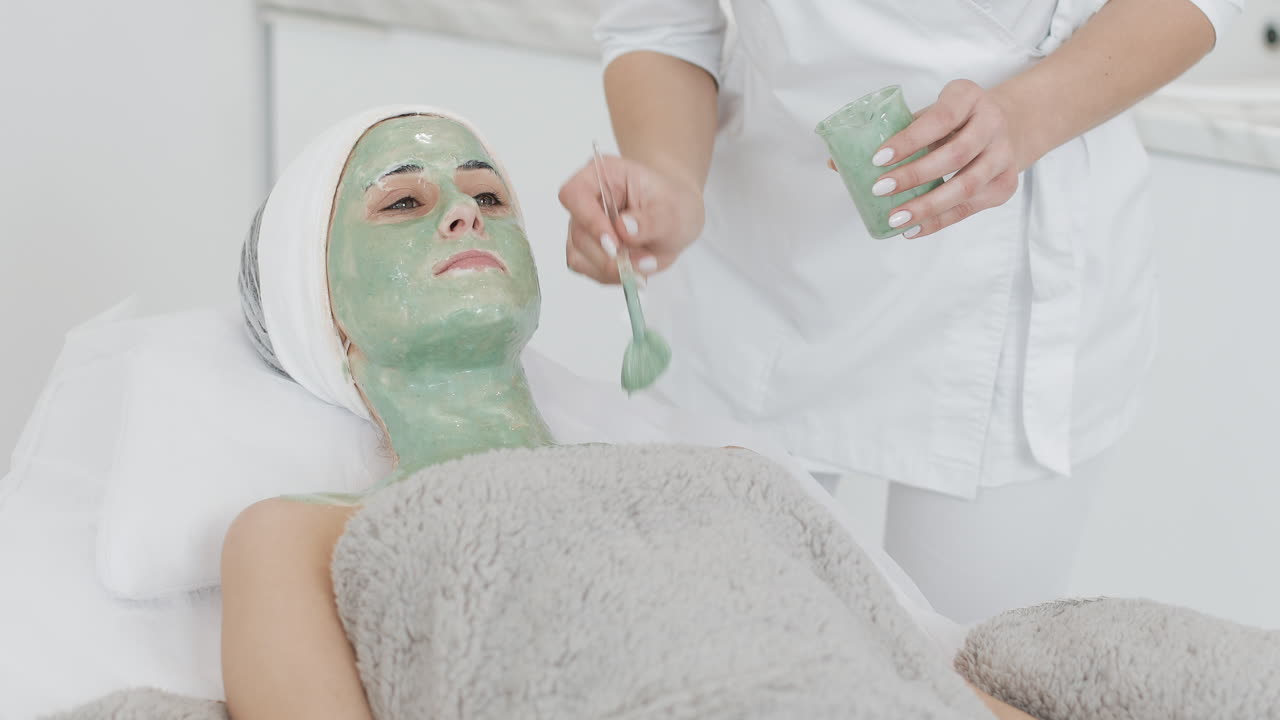 Woman receiving a facial mask at a spa
