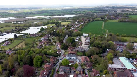 drone footage flying towards a church in a village in kent