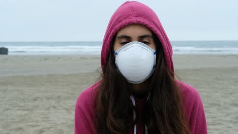 portrait of casual brunette young woman with protective medical face mask