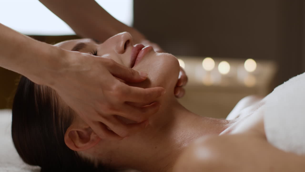 Woman Receiving Facial Massage at a Spa