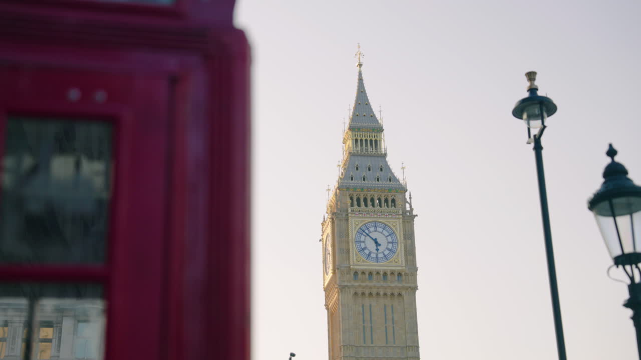 Red Telephone Box With Big Ben, Great Bell of the Great Clock of Westminster In London, UK. - wide shot