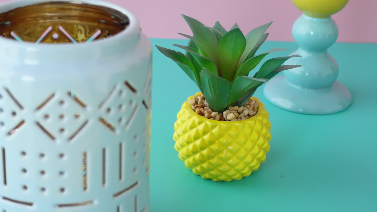 Colorful Home Decor Arrangement with Pineapple Planter and Teal Candle Holder