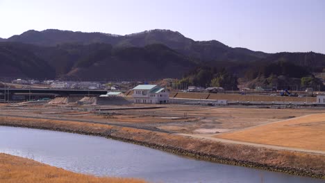 new construction underway at flattened area after tsunami in eastern japan