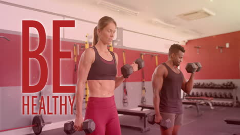 animation of be healthy text over diverse man and woman exercising in gym