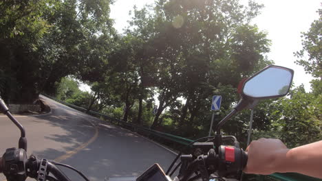 First-person-perspective,-driving-a-motorcycle-in-the-mountains