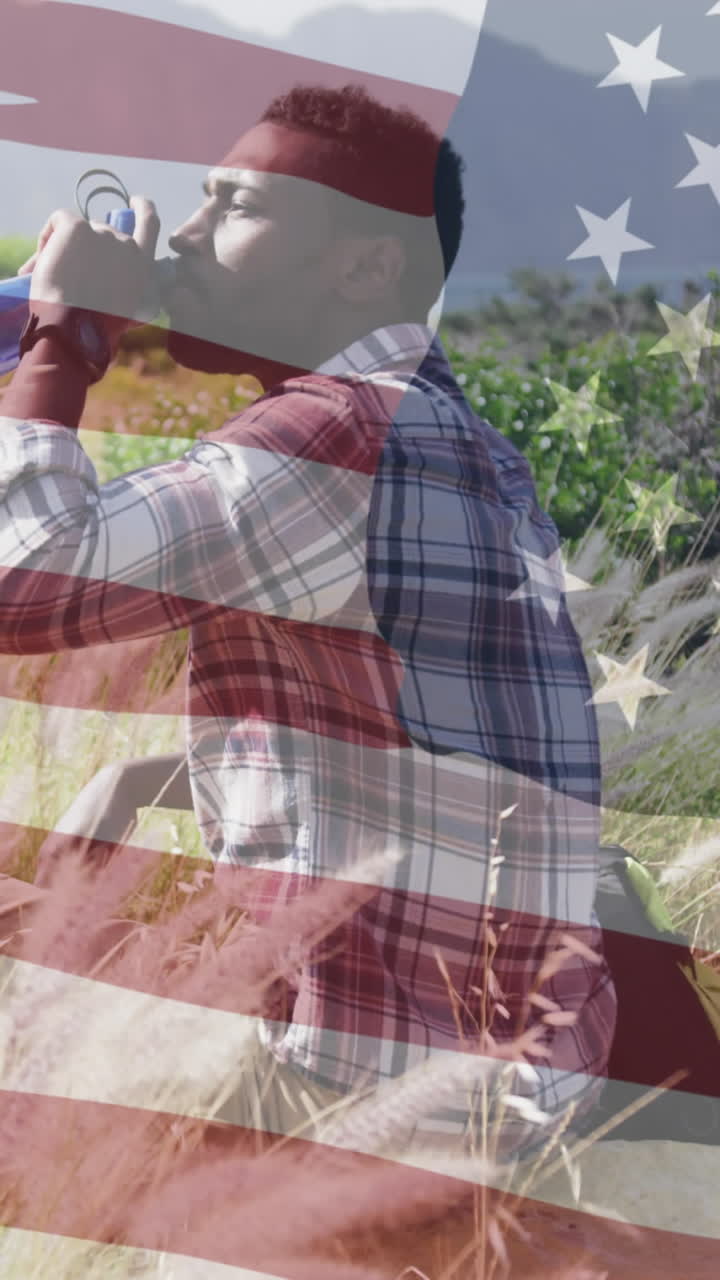 animación de la bandera estadounidense sobre un hombre afroamericano bebiendo agua en las montañas