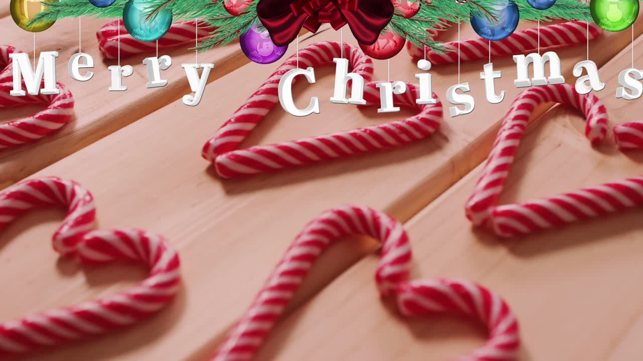 나무 바탕에 사탕 위에 메리 크리스마스 텍스트의 애니메이션
