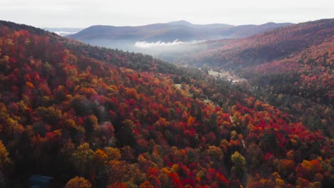 Vermont-mountains-hillsides-with-colorful-vibrant-cover-of-Autumn-leaf-color,-dolly-in-aerial