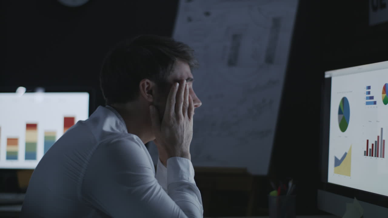 Yawning business man working late