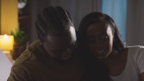 Close-Up-Of-Loving-Couple-Relaxing-At-Home-Sitting-On-Bed-At-Night-Talking-Together-2