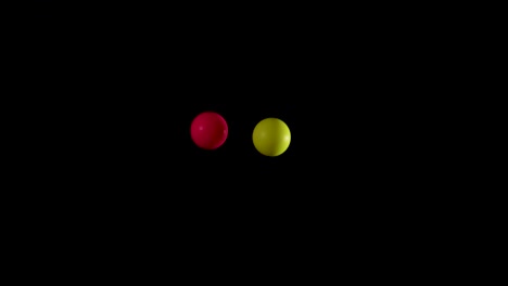 red and yellow balls bouncing in darkness